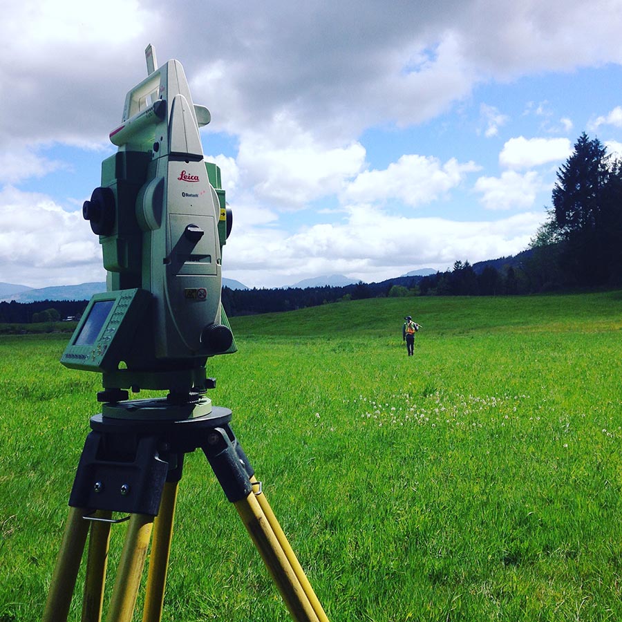 Land surveying equipment in a field with man
